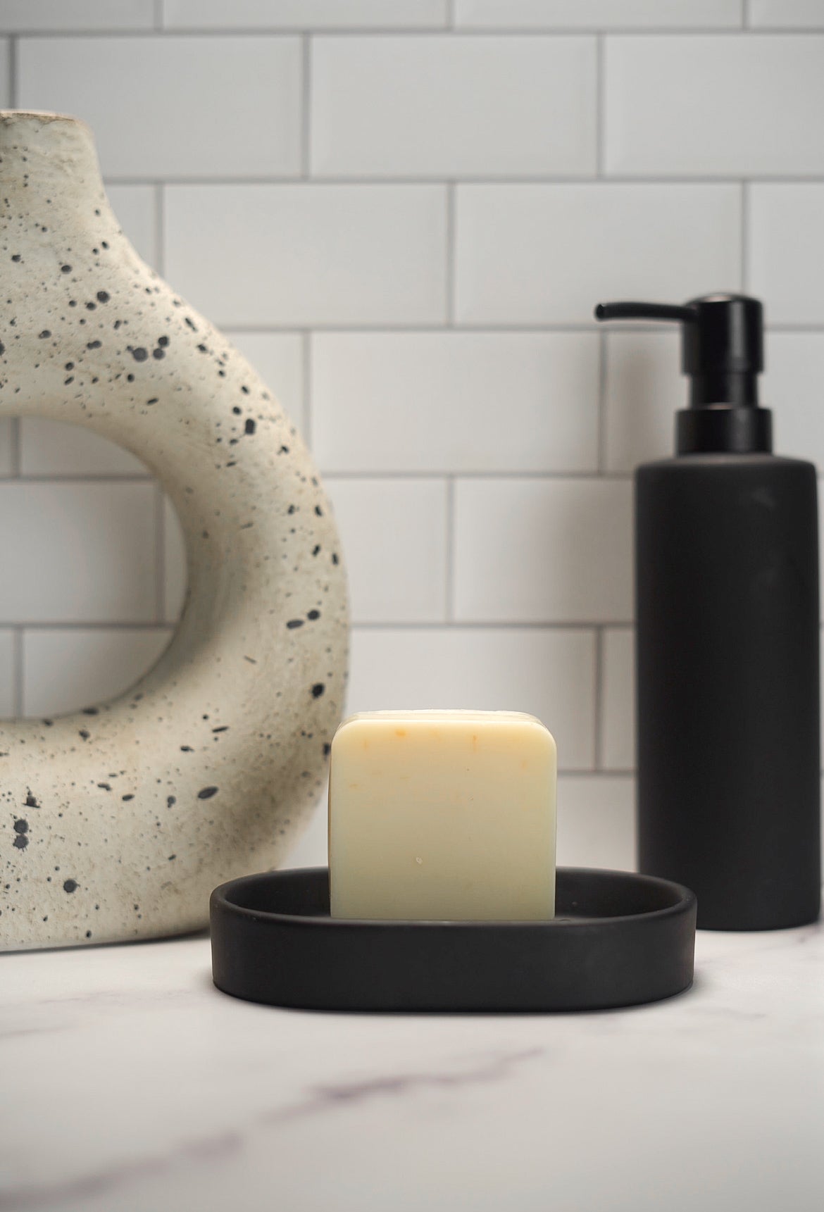 Barebase Fresh Dandelion Soap on ceramic dish in minimalist bathroom