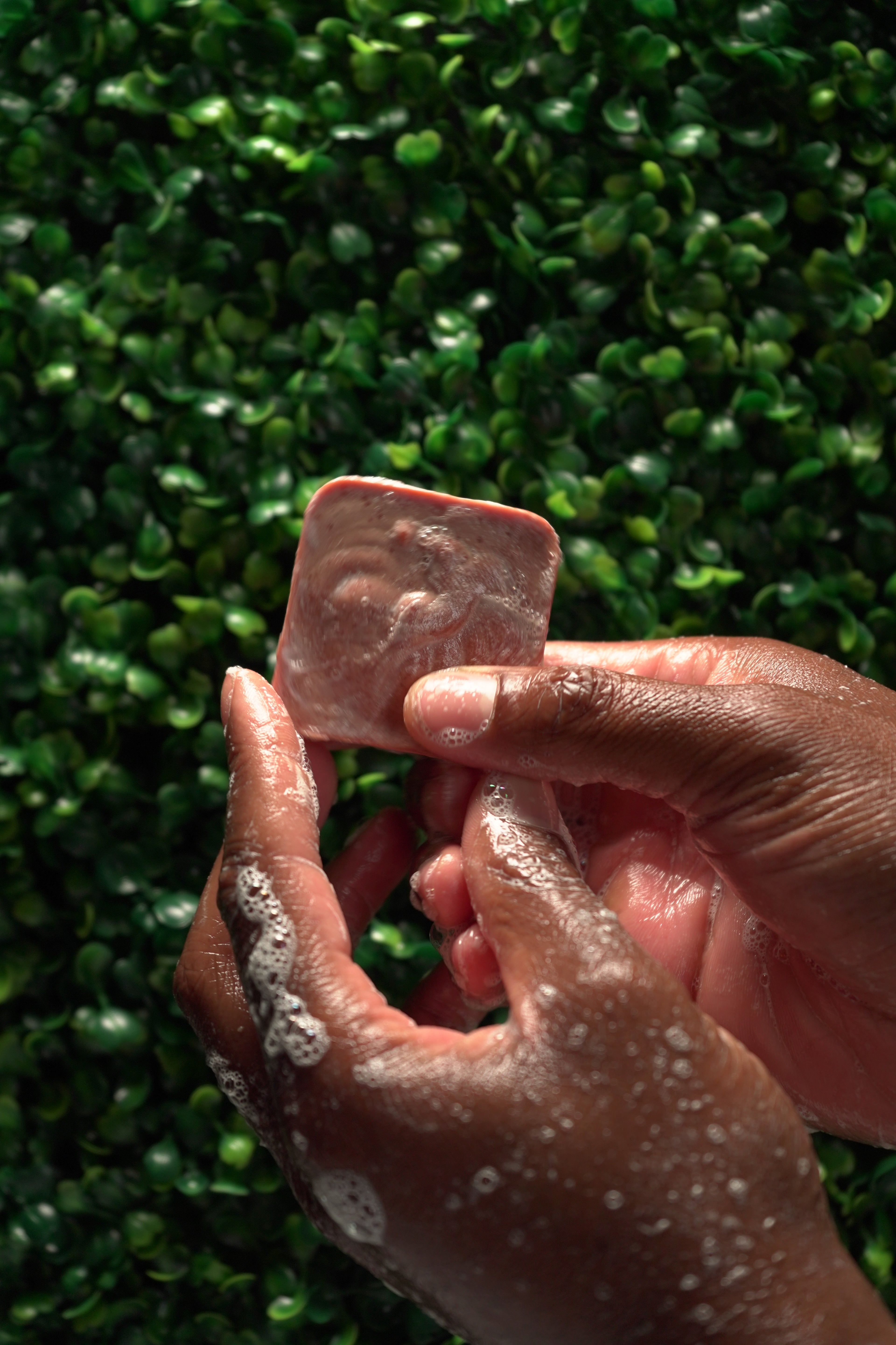 Person washing hands with Barebase Coconut-Free Red Clay Soap Bar