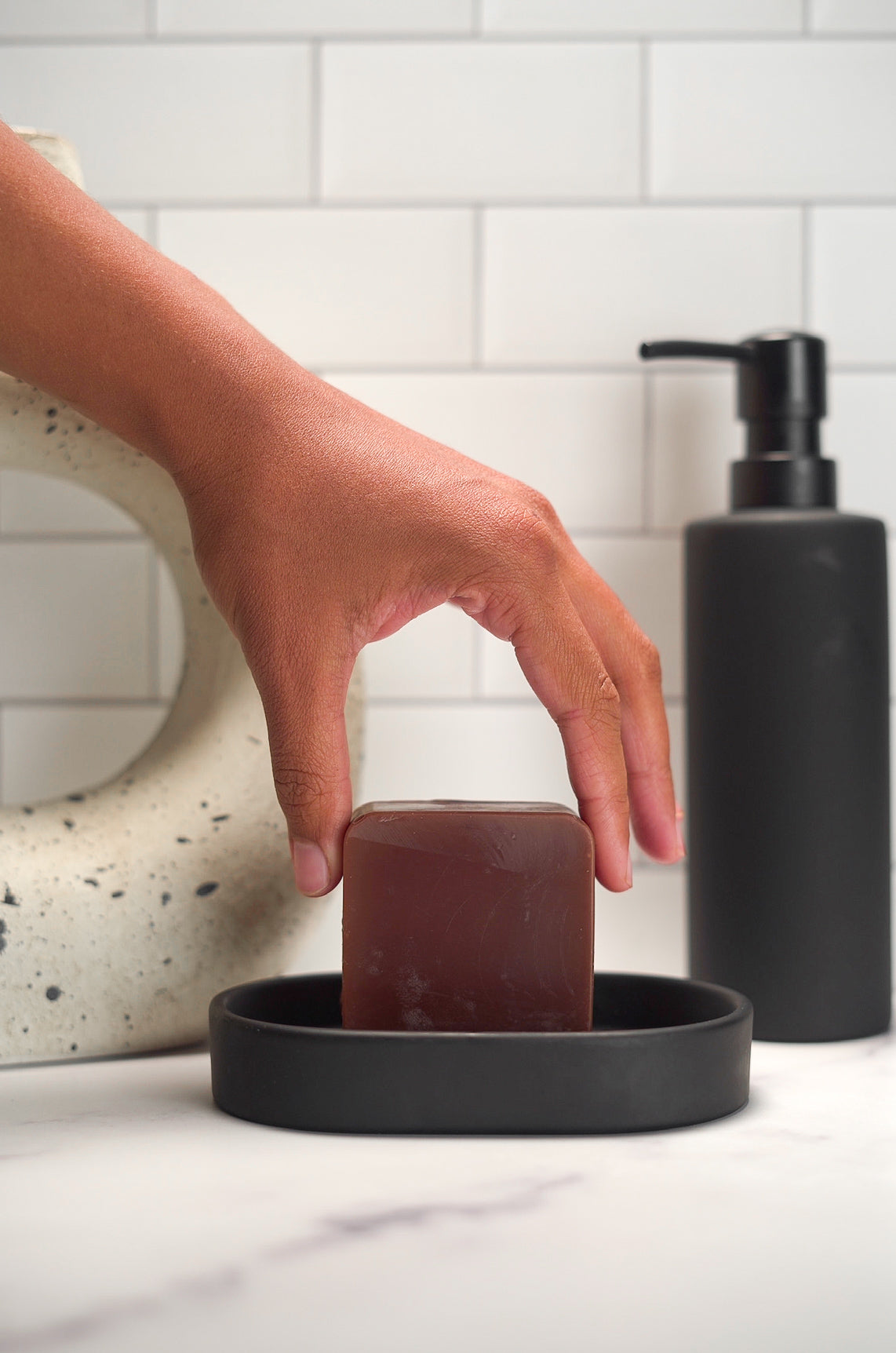 Barebase Coconut-Free Vanilla ChamomileSoap on ceramic dish in minimalist bathroom