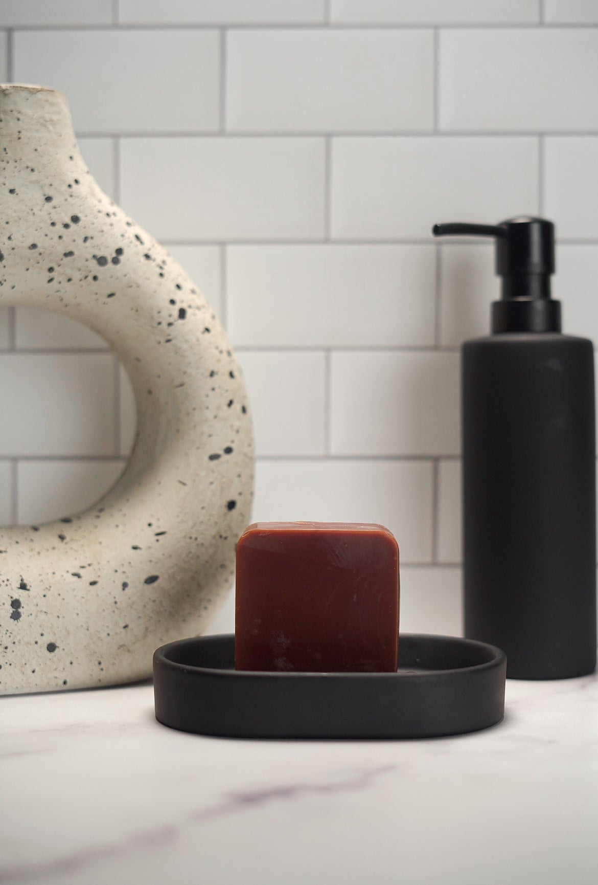 Barebase Vanilla ChamomileSoap on ceramic dish in minimalist bathroom