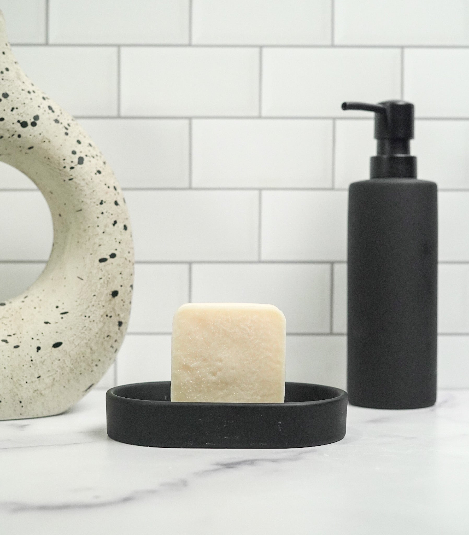 Coconut-Free Dark patchouli Soap Bar on ceramic dish in minimalist bathroom